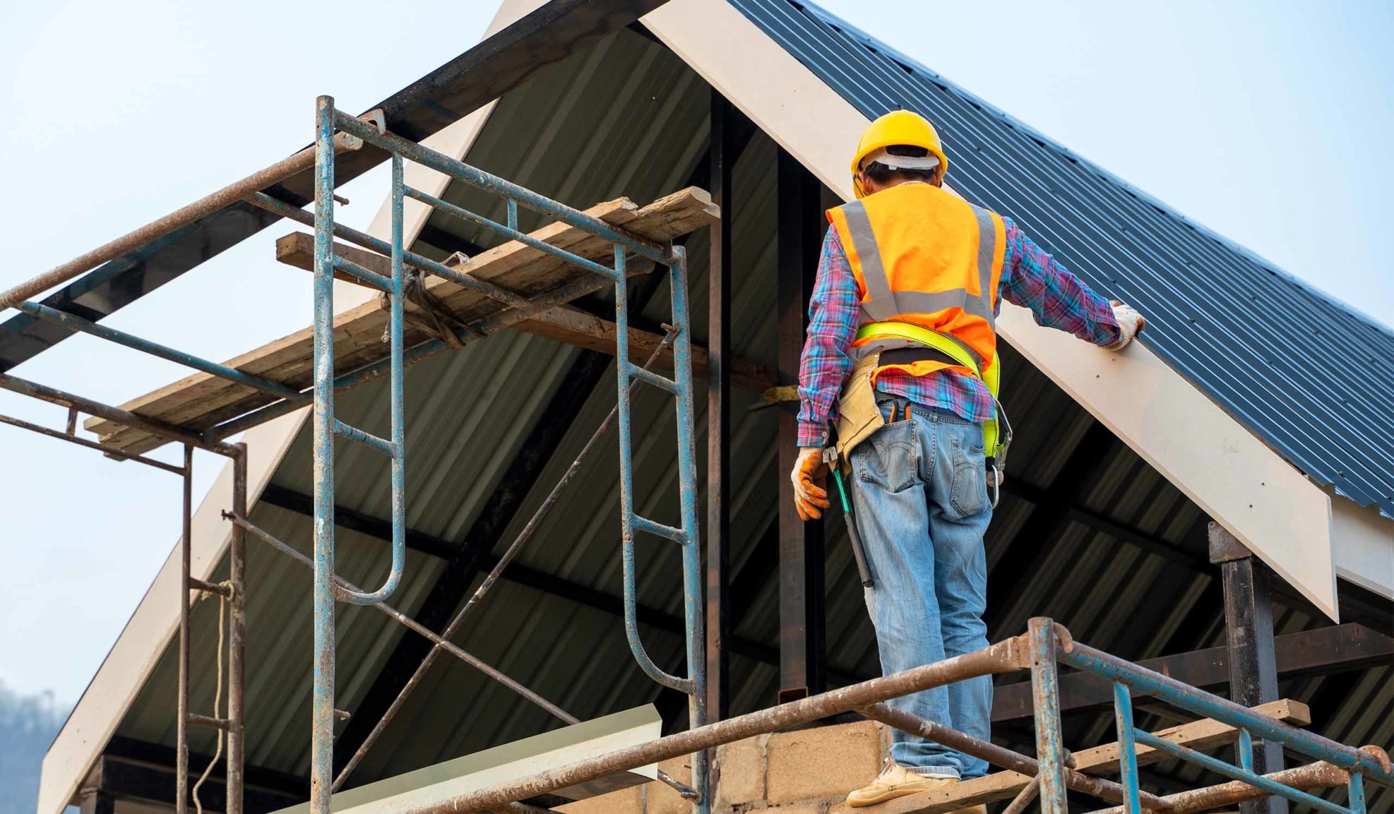 contractor with a vest inspecting a remodeling project hamburg ny